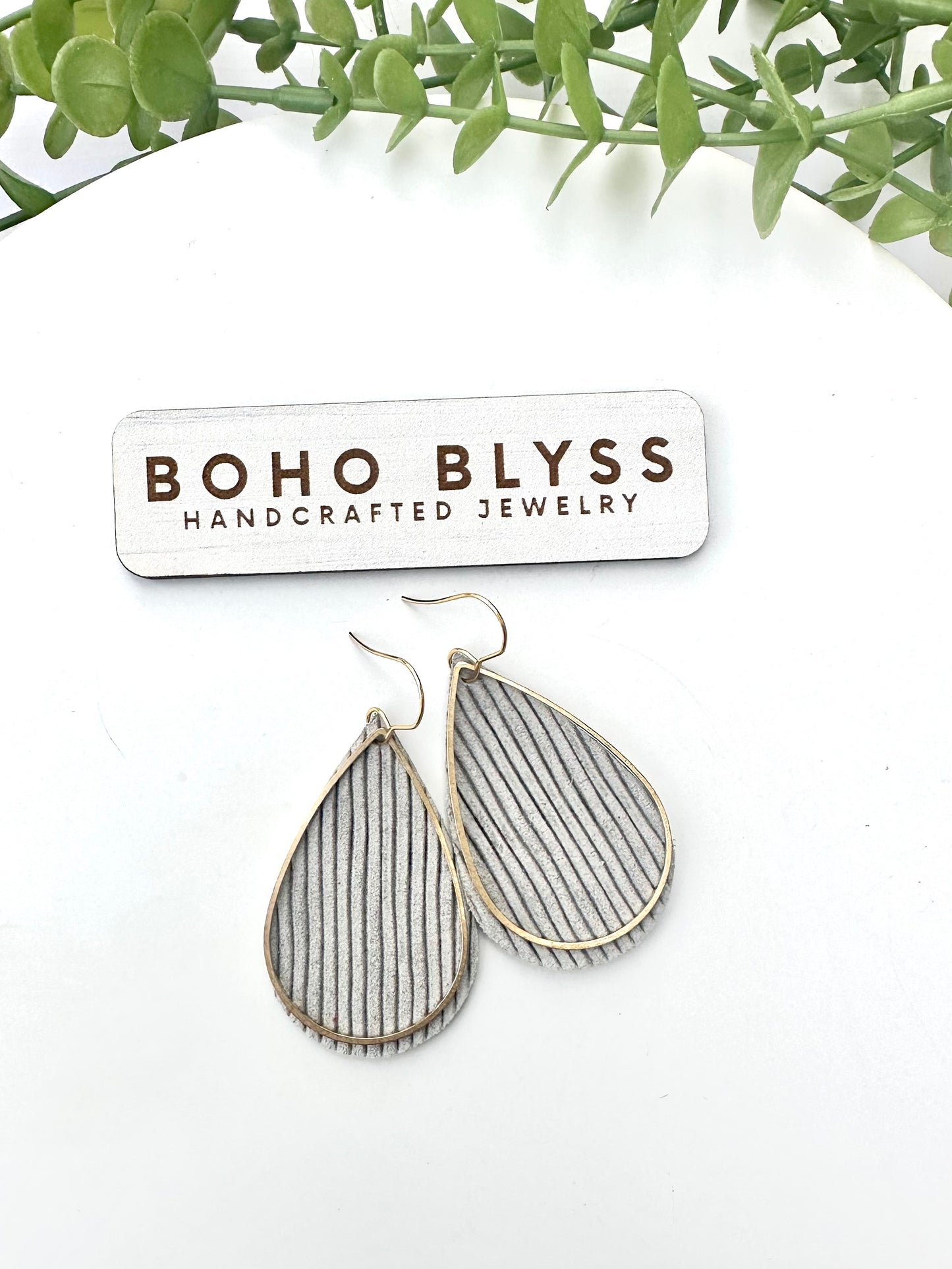 Gray ruffle and brass teardrops